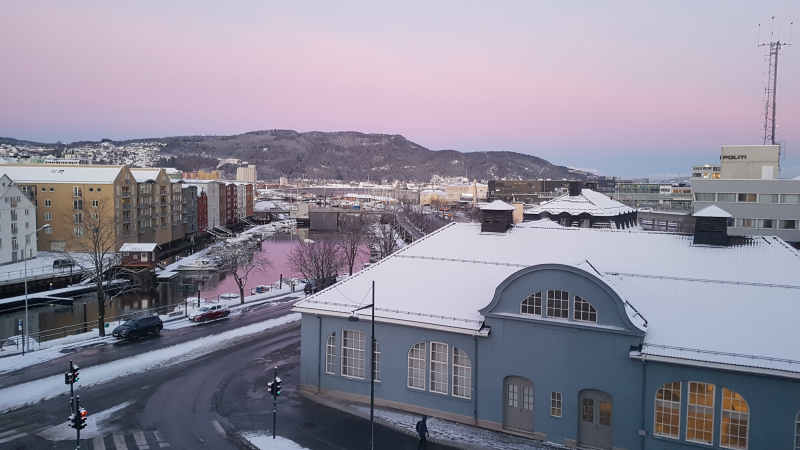 View from my hotel room, showing slightly snowy roofs and a gloriously lilac sky