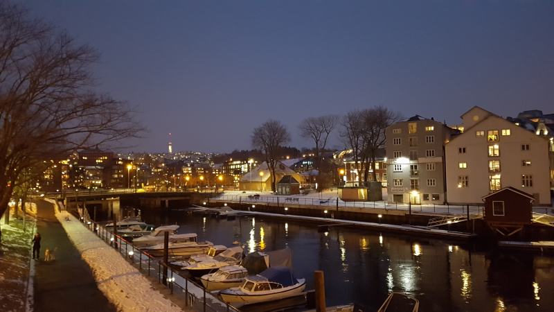 The canal in Trondheim, with a little snow, as the town lights up in the dark